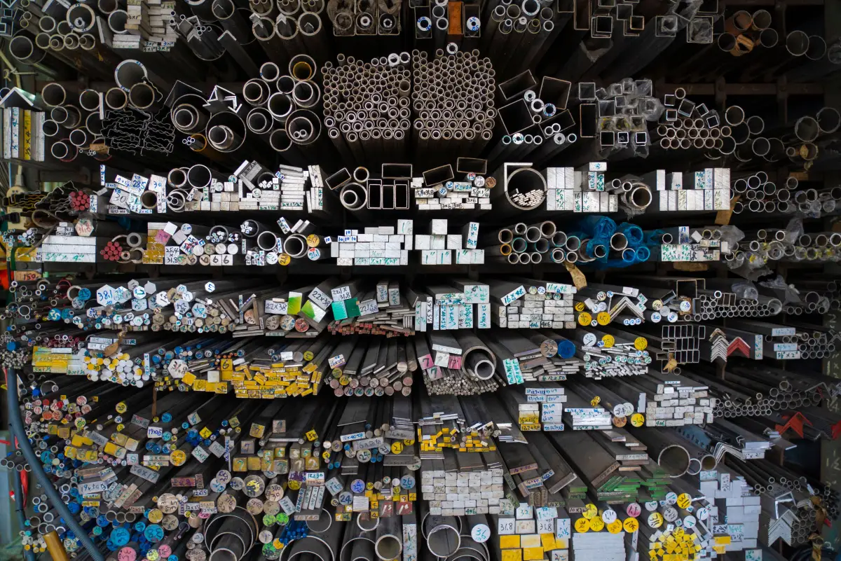 Racked steel tube, angle and bar stock sorted by profile in a fabrication shop