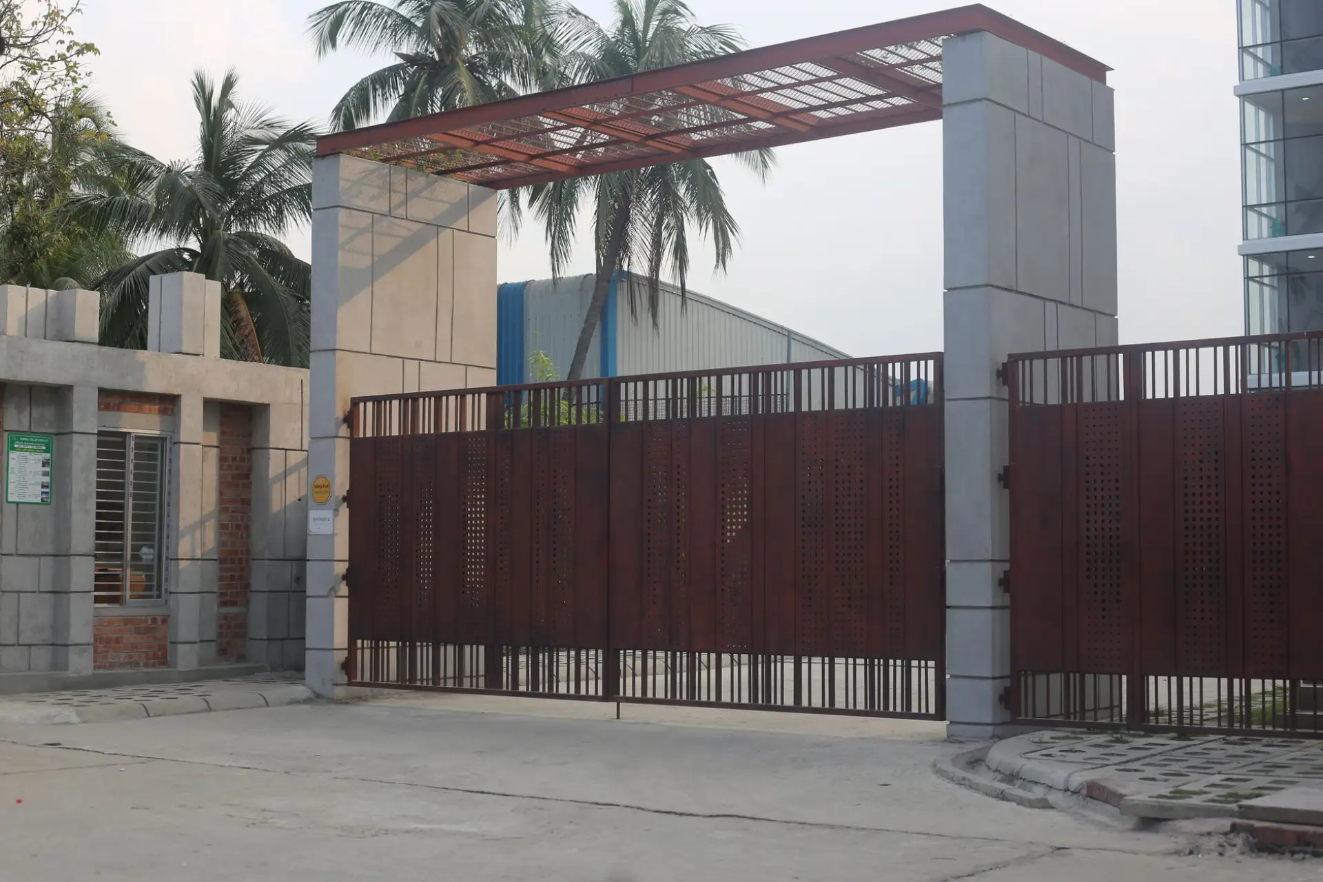 A large automatic iron gate at the entrance to a modern building