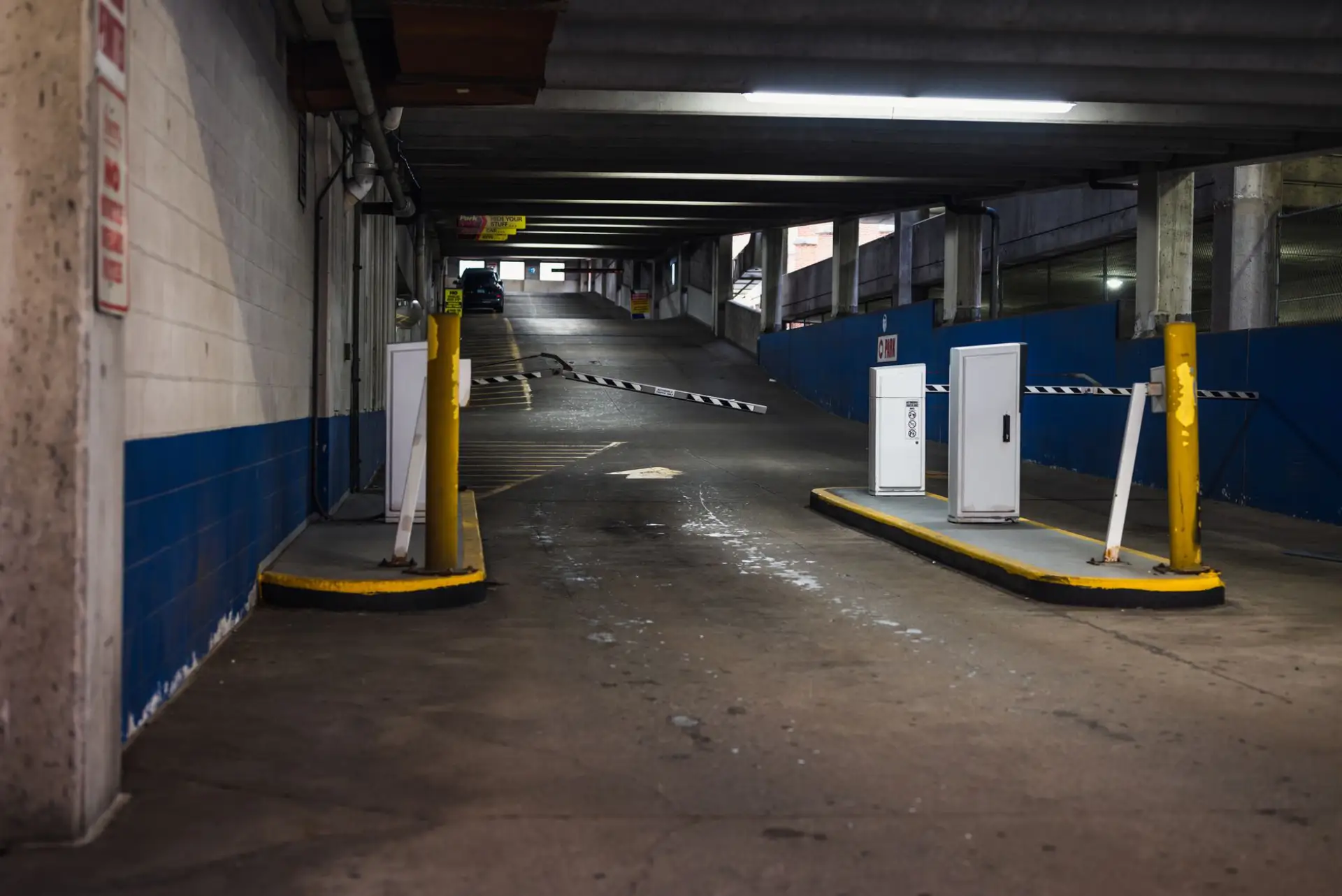 An automatic barrier gate at the entrance ramp to a commercial parking structure