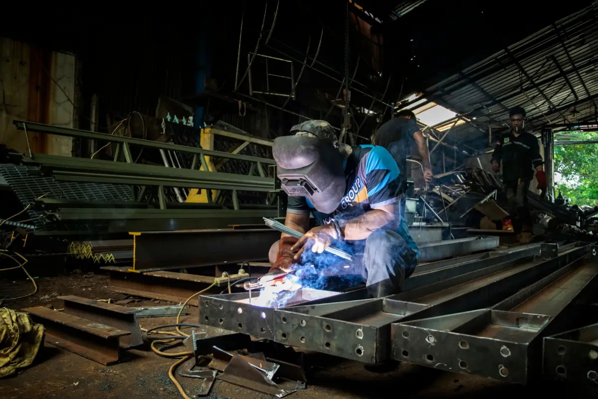 A technician welding during a commercial gate repair