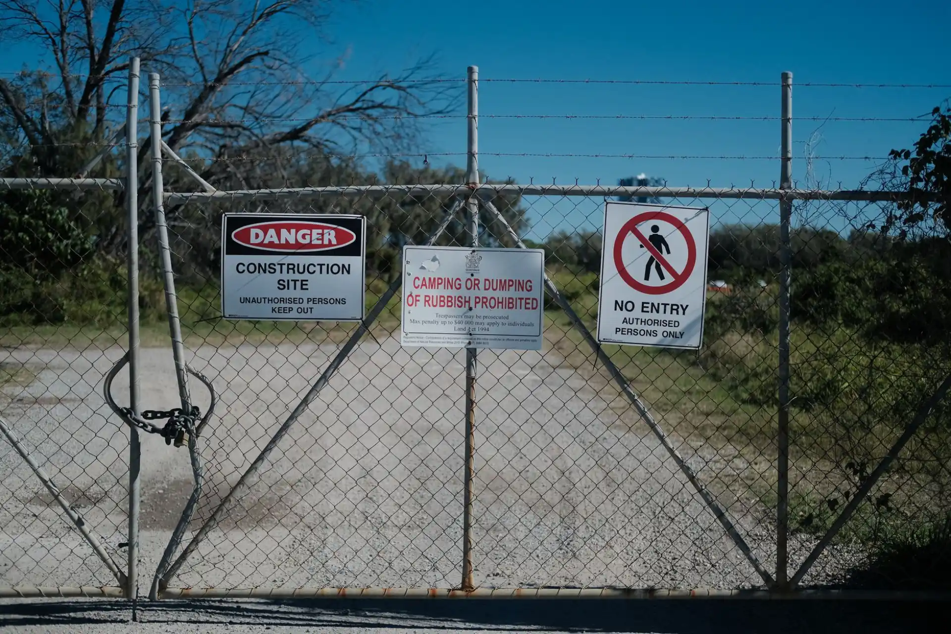 A commercial security gate carrying restricted-access signage