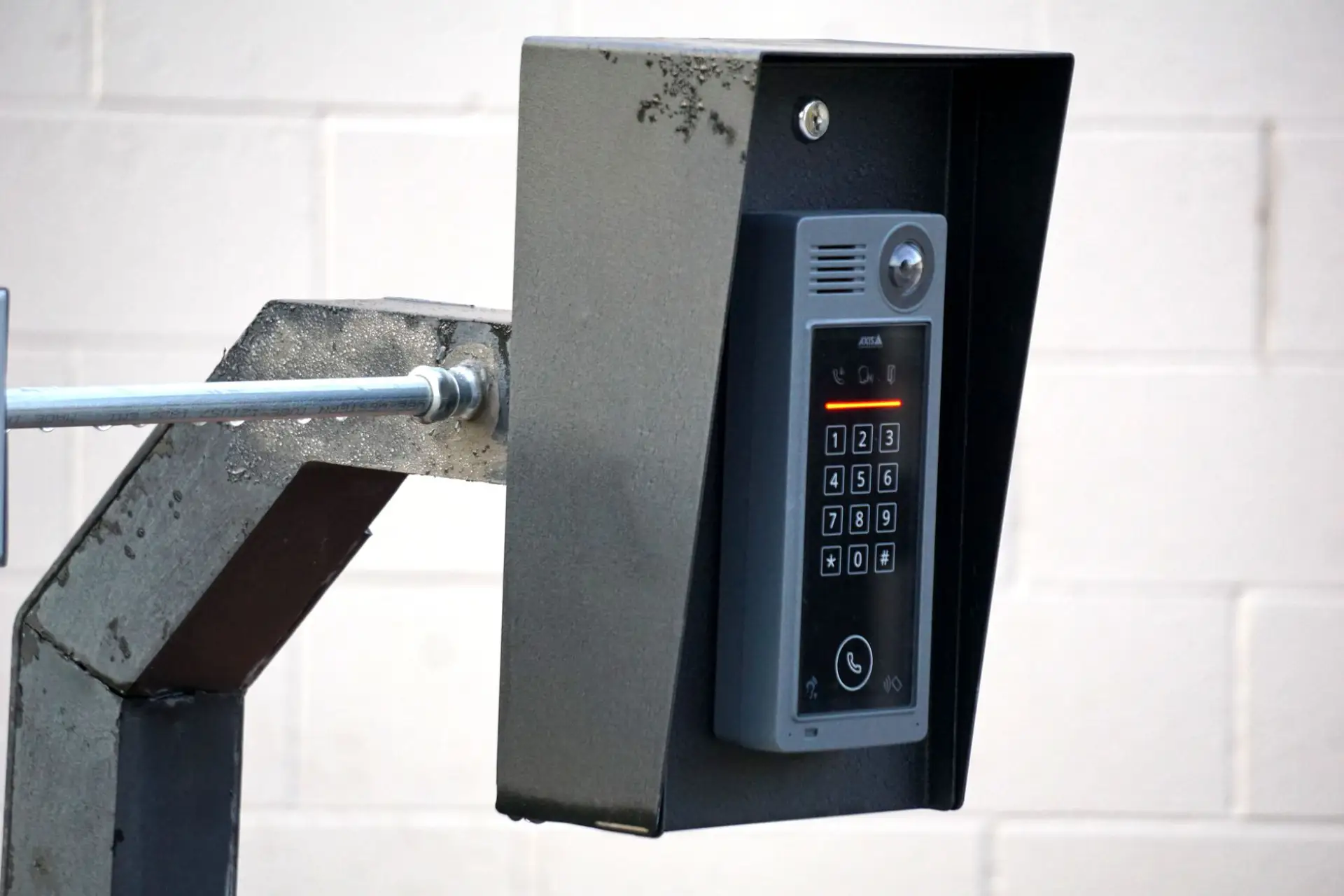 A gate access control keypad and intercom unit mounted at an entrance