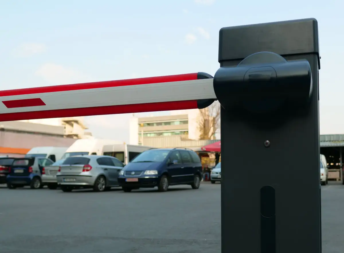 A vehicle barrier gate controlled by an access system, cars waiting behind